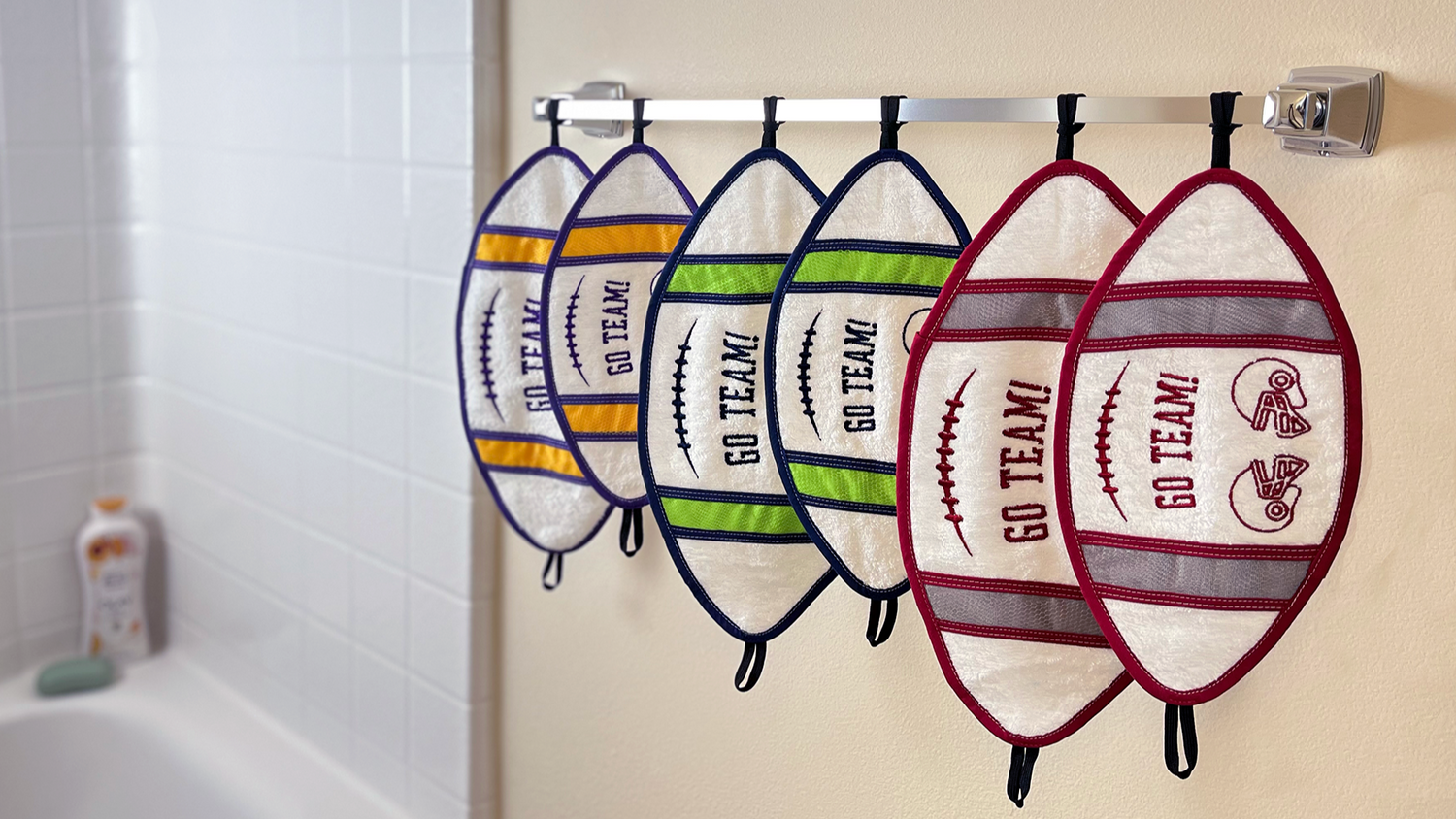 Football towels hanging on a shower rack